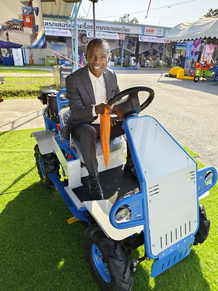 Compact riding tractor on display at an agricultural machinery expo