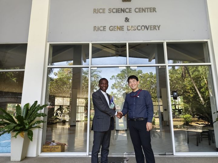 Handshake in front of the Rice Science Center and Rice Gene Discovery building