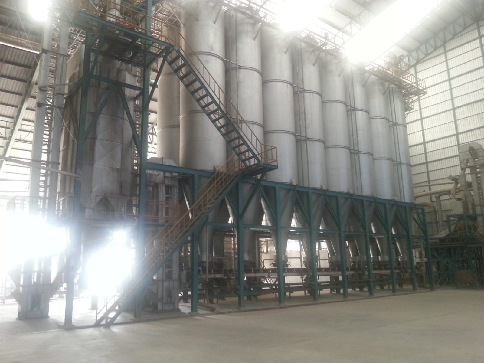 Row of steel storage silos inside a modern rice mill